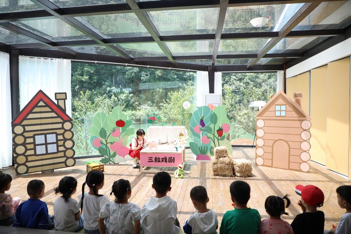 孩子們整齊地坐成一排，專心觀看《小象波米諾》。