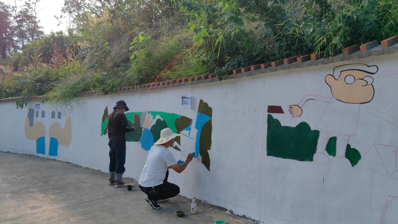 在“繪畫師”繁忙而有序的勾勒下，一幅幅精致的繪畫與墻體巧妙融合 唐世蕓 攝.jpeg