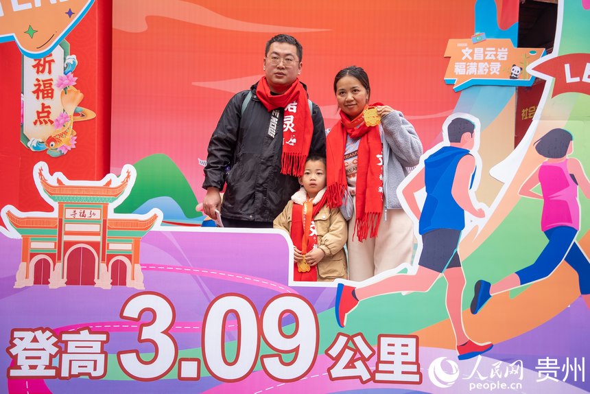 參與貴陽貴安第53屆全民健身登高迎新跑的市民在終點打卡拍照。人民網記者 涂敏攝