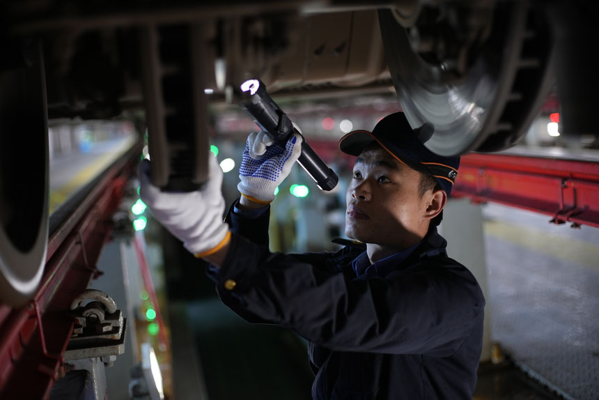 張淼奕正在認真檢查車輛底部情況。李儒鑫攝