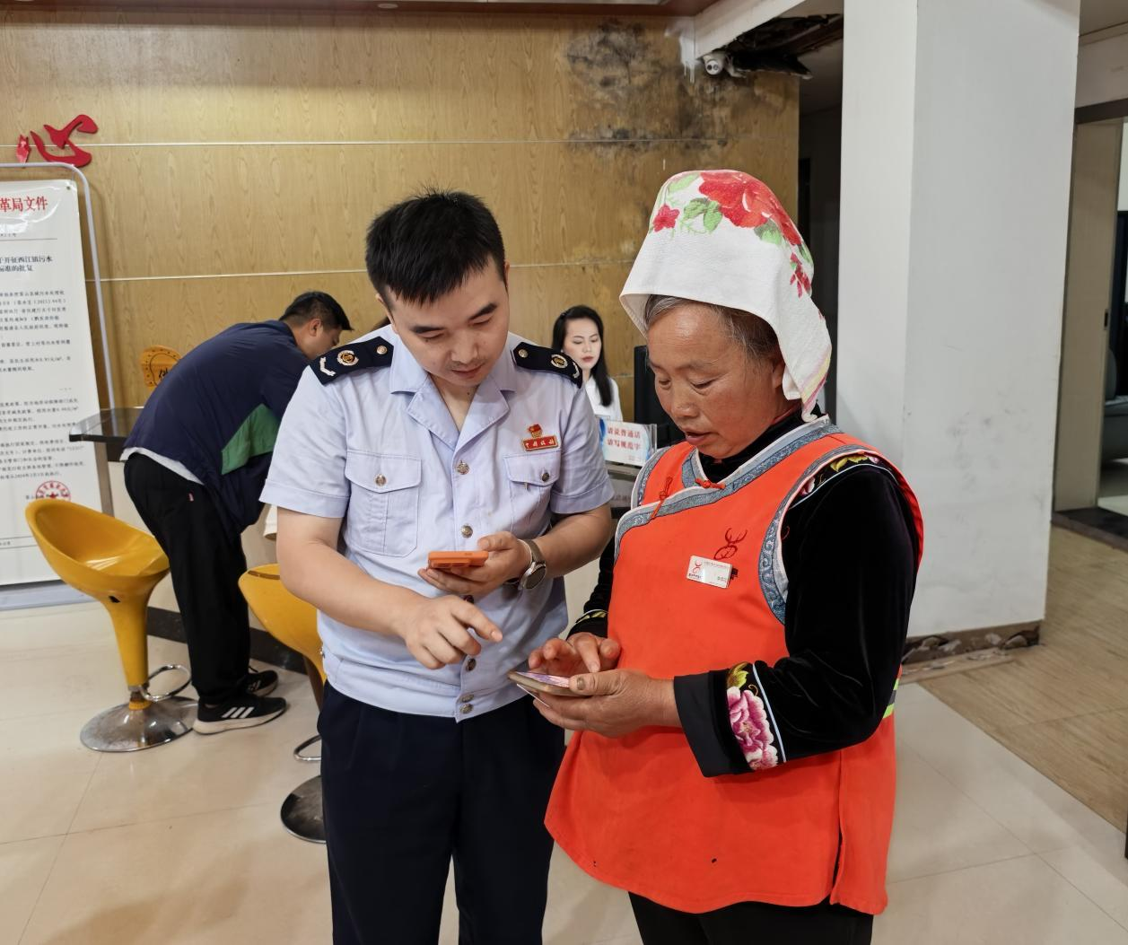 稅務干部為環衛工人講解個稅匯算流程。