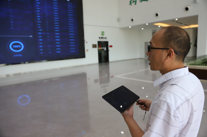 在手機上辦理貴陽農產品物流園手續。文俊入攝